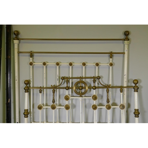 1085 - A Victorian cast iron and brass bed, 171cm high, 143cm wide, 200cm long