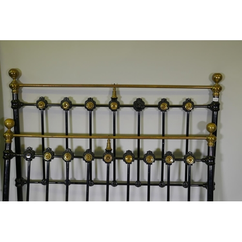 1086 - A Victorian cast iron and brass bed, 146cm high, 140cm wide, 194cm long