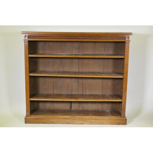 1087 - A Victorian walnut open bookcase, with moulded frieze and carved paterae, three adjustable shelves, ... 