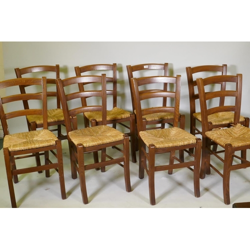 1094 - A set of eight French style ladderback chairs with rush seats, one AF