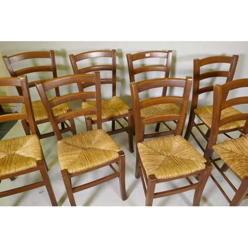 1094 - A set of eight French style ladderback chairs with rush seats, one AF