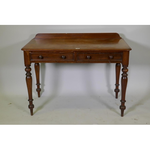 1095 - A Victorian mahogany writing table, two drawers with moulded fronts and turned wood handles, raised ... 