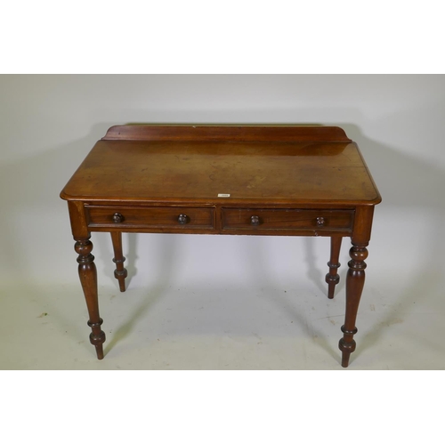 1095 - A Victorian mahogany writing table, two drawers with moulded fronts and turned wood handles, raised ... 