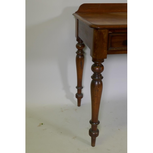 1095 - A Victorian mahogany writing table, two drawers with moulded fronts and turned wood handles, raised ... 