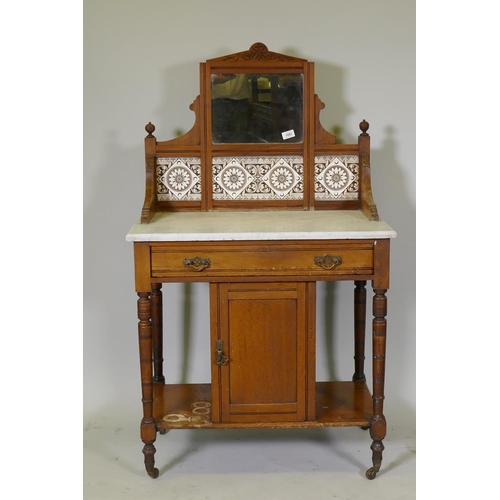 1097 - A Victorian walnut marble top washstand with tiled and mirror back over a single drawer and pot cupb... 