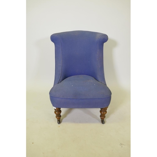 1098 - A Victorian nursing chair with shaped back, raised on turned supports with brass castors