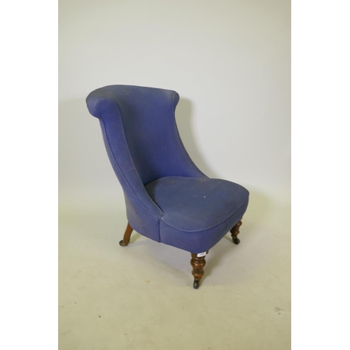 1098 - A Victorian nursing chair with shaped back, raised on turned supports with brass castors