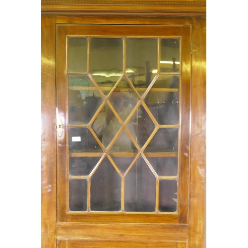 1100 - A George III mahogany standing corner cabinet, with astragal glazed door over cupboard, raised on a ... 