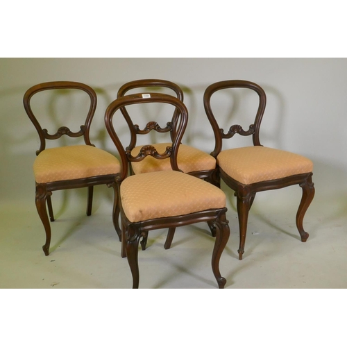 1102 - Four Victorian rosewood balloon back dining chairs, with carved details