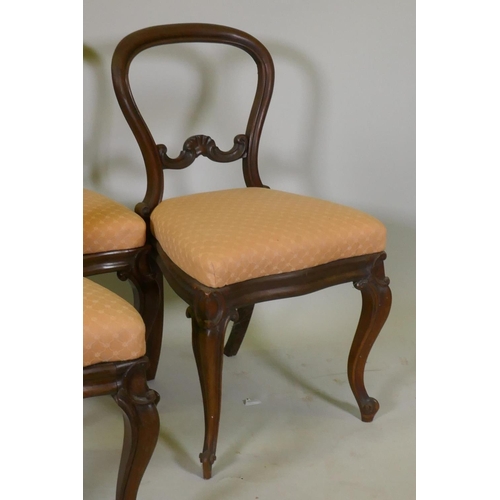 1102 - Four Victorian rosewood balloon back dining chairs, with carved details