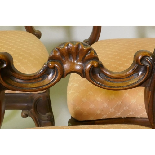 1102 - Four Victorian rosewood balloon back dining chairs, with carved details