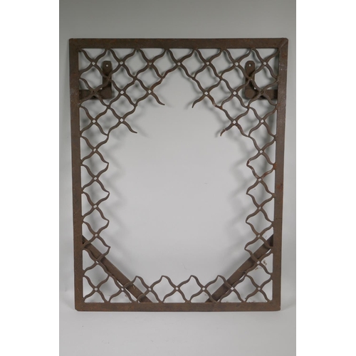 1105 - An Indian wrought metal lattice mirror frame, 59 x 76cm