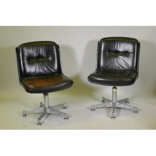 1108 - A pair of mid century leather swivel chairs, raised on polished aluminium spider leg bases, stamped ... 