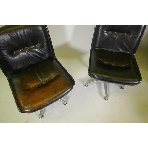 1108 - A pair of mid century leather swivel chairs, raised on polished aluminium spider leg bases, stamped ... 