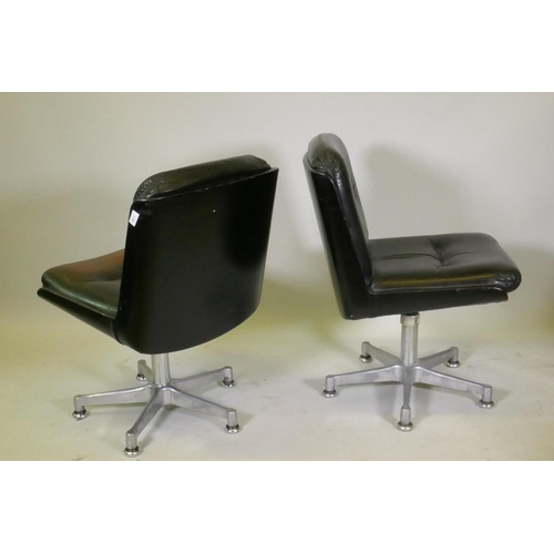 1108 - A pair of mid century leather swivel chairs, raised on polished aluminium spider leg bases, stamped ... 