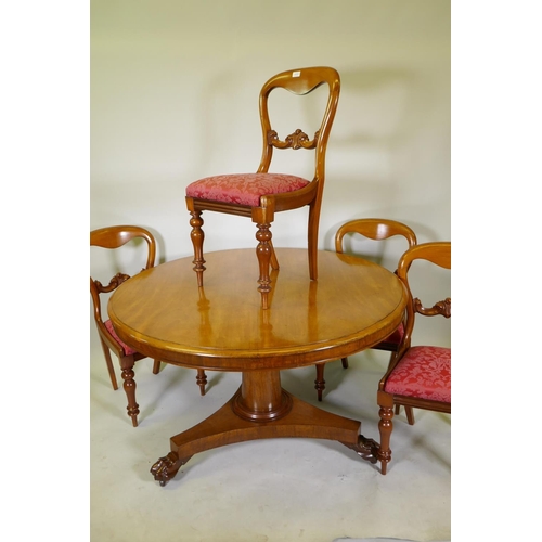 1111 - A Victorian mahogany tilt top breakfast table, raised on a column and triform base with claw feet an... 