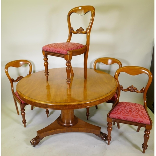 1111 - A Victorian mahogany tilt top breakfast table, raised on a column and triform base with claw feet an... 