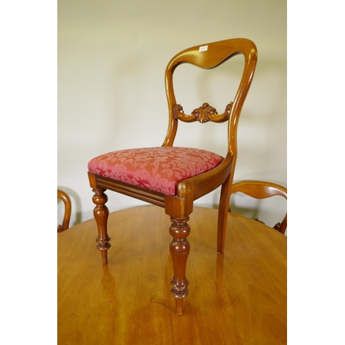 1111 - A Victorian mahogany tilt top breakfast table, raised on a column and triform base with claw feet an... 