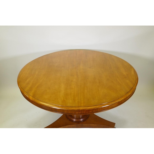 1111 - A Victorian mahogany tilt top breakfast table, raised on a column and triform base with claw feet an... 