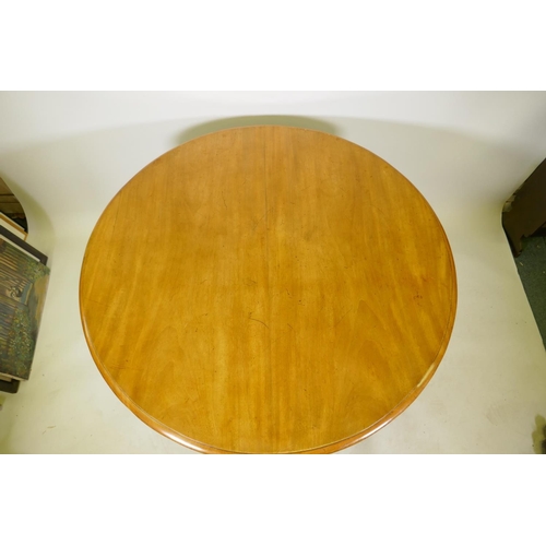 1111 - A Victorian mahogany tilt top breakfast table, raised on a column and triform base with claw feet an... 