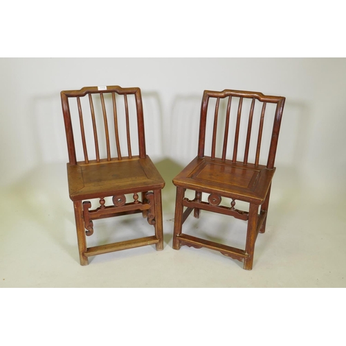 1112 - A near pair of Chinese elm spindle back low chairs, 70cm high