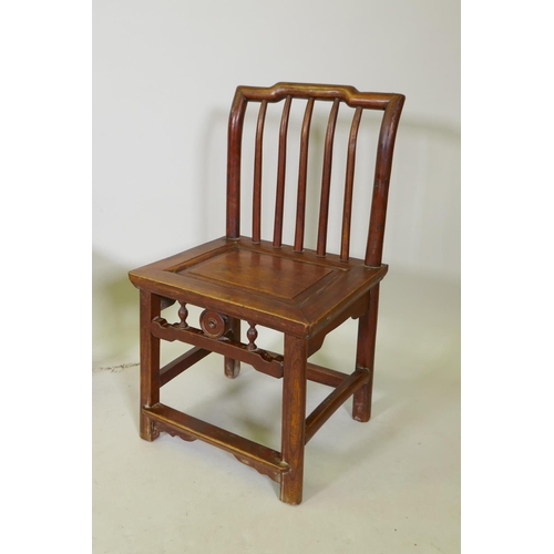 1112 - A near pair of Chinese elm spindle back low chairs, 70cm high