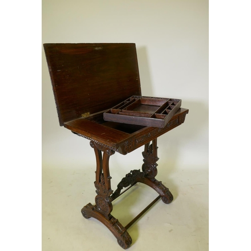 1121 - A C19th Colonial  Anglo-Indian padouk work/dressing table, with lift up top and removable fitte... 