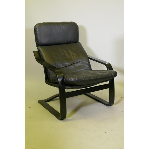 1129 - A leatherette easy chair with ebonised bentwood frame