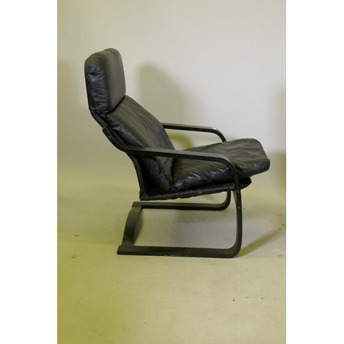 1129 - A leatherette easy chair with ebonised bentwood frame