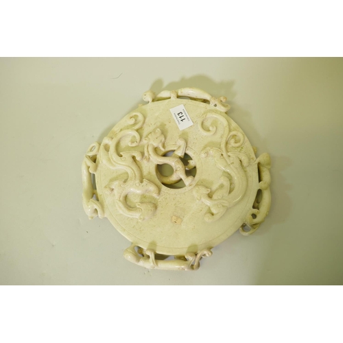 113 - A Chinese carved soapstone pi disc decorated with nine dragons, 27cm diameter