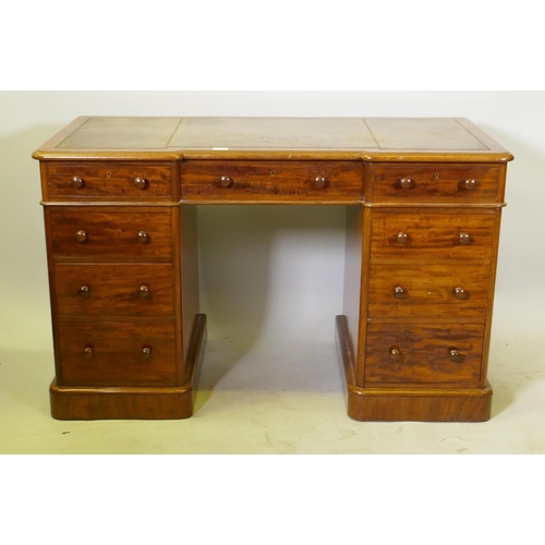 1131 - A Victorian Heal & Son nine drawer mahogany pedestal desk, the inverted breakfront top with gilt... 