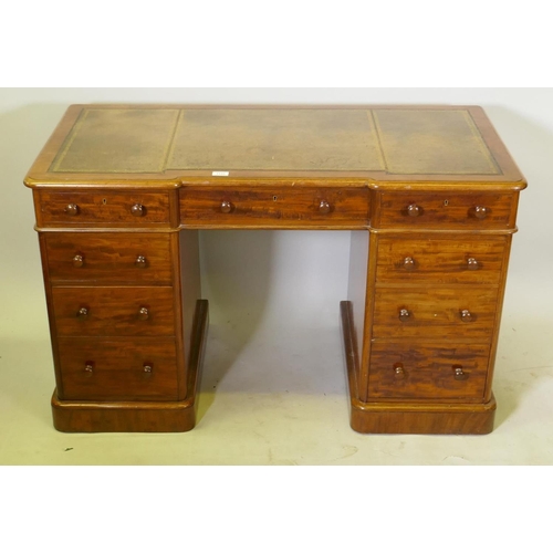 1131 - A Victorian Heal & Son nine drawer mahogany pedestal desk, the inverted breakfront top with gilt... 