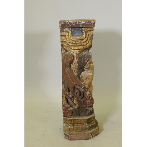 1136 - A carved and polychrome painted wood pedestal/stand in the form of a putto holding aloft a stand wit... 