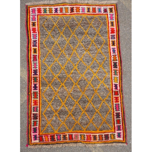 1138 - A Persian Ghashghai Gabbeh hand spun wool full pile nomad rug with a yellow diamond design on a grey... 