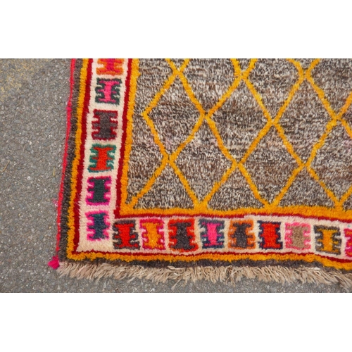 1138 - A Persian Ghashghai Gabbeh hand spun wool full pile nomad rug with a yellow diamond design on a grey... 