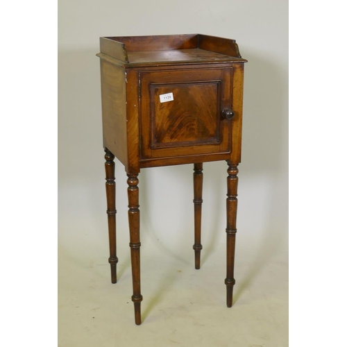 1139 - A George III mahogany bedside pot cupboard, with three quarter gallery top and single door, raised o... 