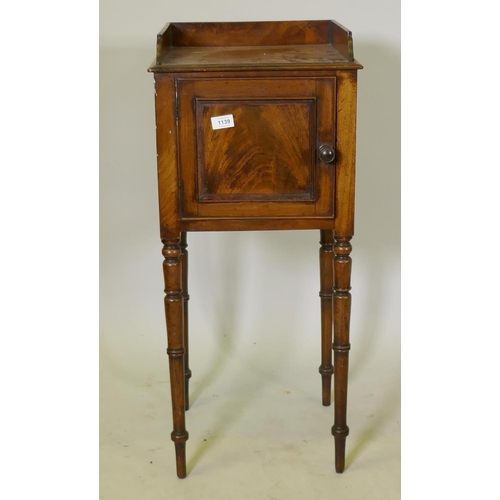 1139 - A George III mahogany bedside pot cupboard, with three quarter gallery top and single door, raised o... 