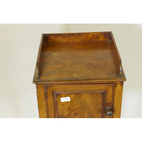 1139 - A George III mahogany bedside pot cupboard, with three quarter gallery top and single door, raised o... 