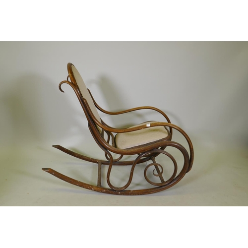 1143 - An early C20th Thonet style bentwood rocking chair with caned seat and back