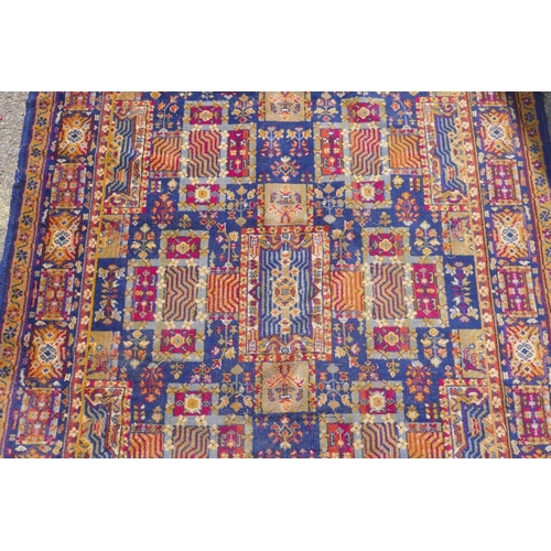 1146 - A vintage oriental wool carpet with all over geometric designs on a blue field, 140 x 197cm