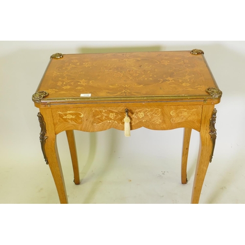 1150 - A French marquetry inlaid rosewood card table with brass mounts, the top slide back to reveal a writ... 