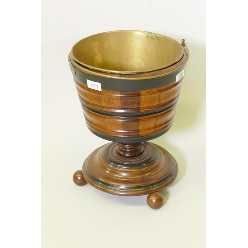 1152 - A Dutch fruitwood wine cooler with ebonised decoration and brass liner, 30cm diameter, 39cm high