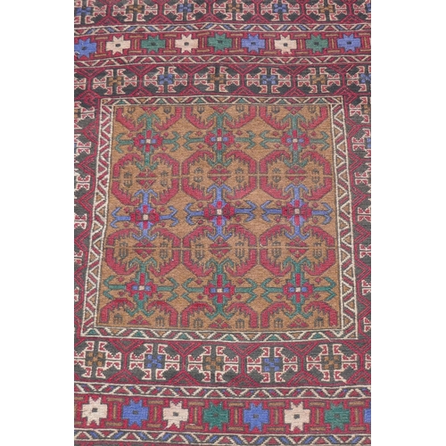 1153 - A Middle Eastern wool rug with red borders around a gold coloured central medallion pattern, 96 x 12... 