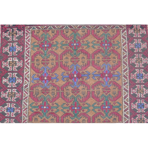 1153 - A Middle Eastern wool rug with red borders around a gold coloured central medallion pattern, 96 x 12... 