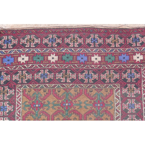 1153 - A Middle Eastern wool rug with red borders around a gold coloured central medallion pattern, 96 x 12... 