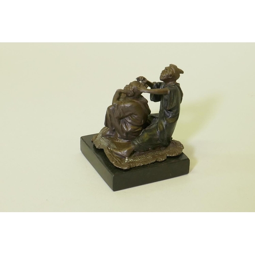 116 - Bronze figure of a barber with customer, mounted on a polished slate base, 8cm high