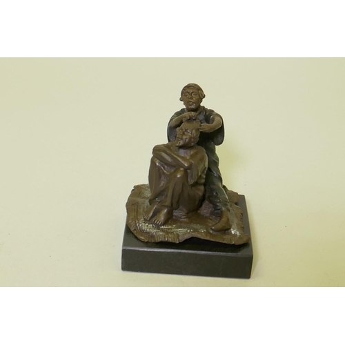 116 - Bronze figure of a barber with customer, mounted on a polished slate base, 8cm high