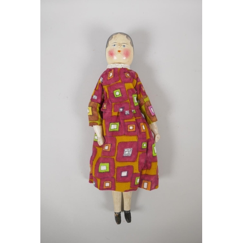 12 - A C19th German Grodnertal doll with hand painted hair, eyes, lips and cheeks, 37cm