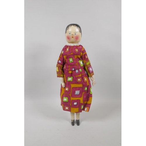 12 - A C19th German Grodnertal doll with hand painted hair, eyes, lips and cheeks, 37cm