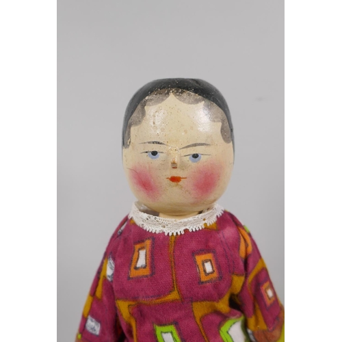 12 - A C19th German Grodnertal doll with hand painted hair, eyes, lips and cheeks, 37cm